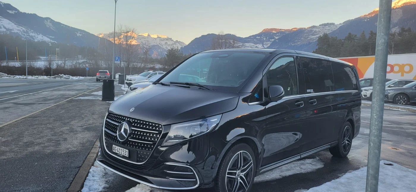 Black Mercedes van on a winter journey in the Swiss Alps