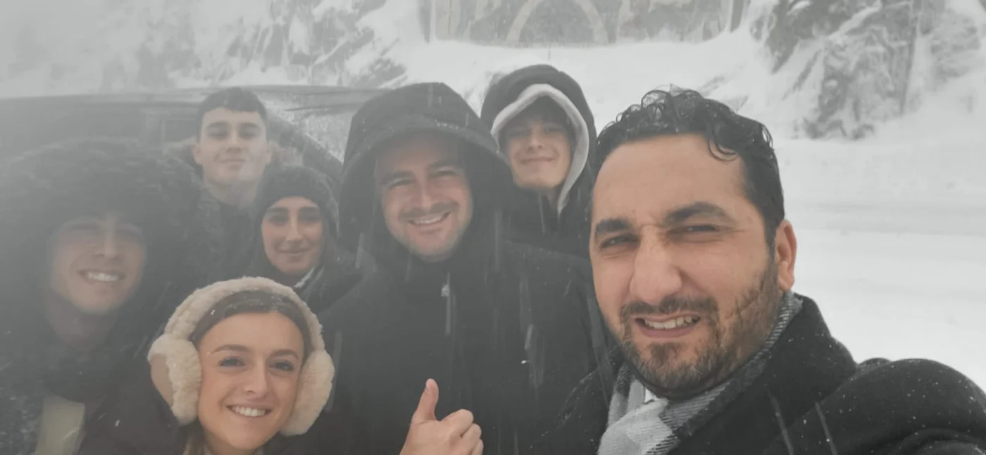 Ali with guests during a snowy mountain journey